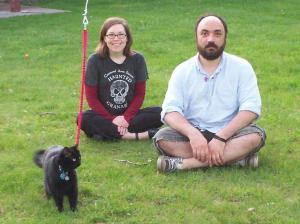 Sarah, Chris and thier cat in the backyard